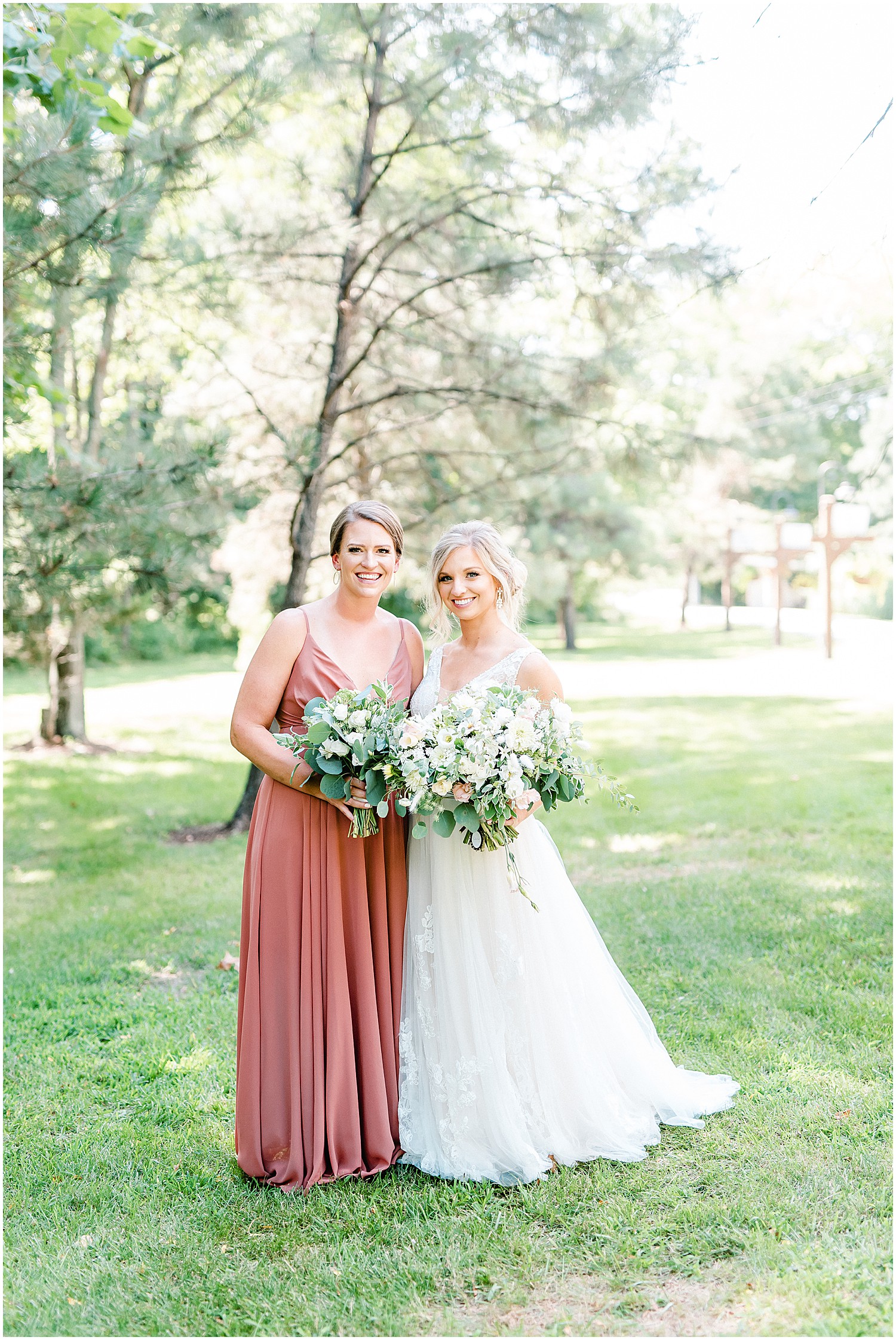 bride and bridesmaid in dusty pink mauve dress during portraits at little piney lodge