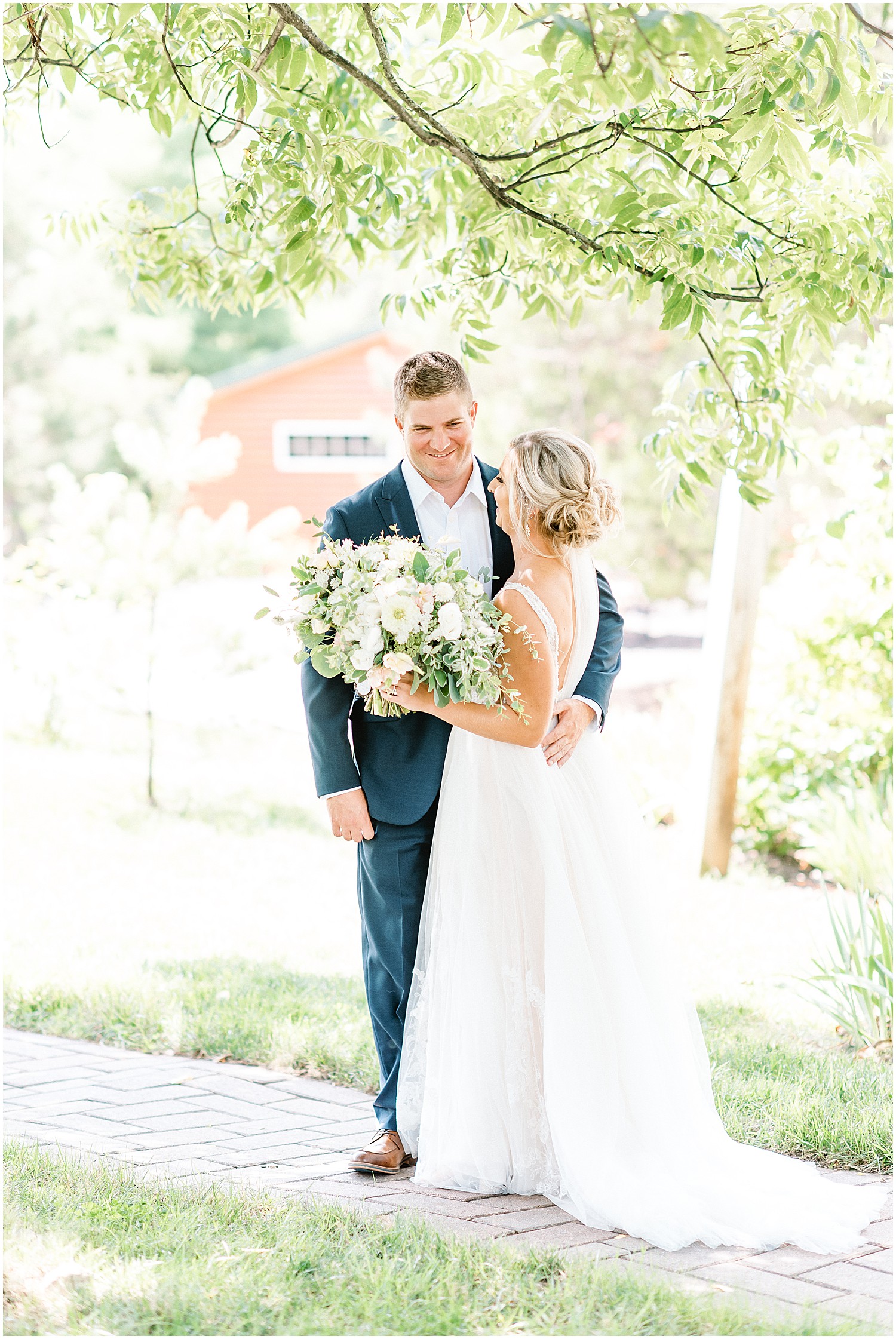 bride and groom after first look under tree at little piney lodge