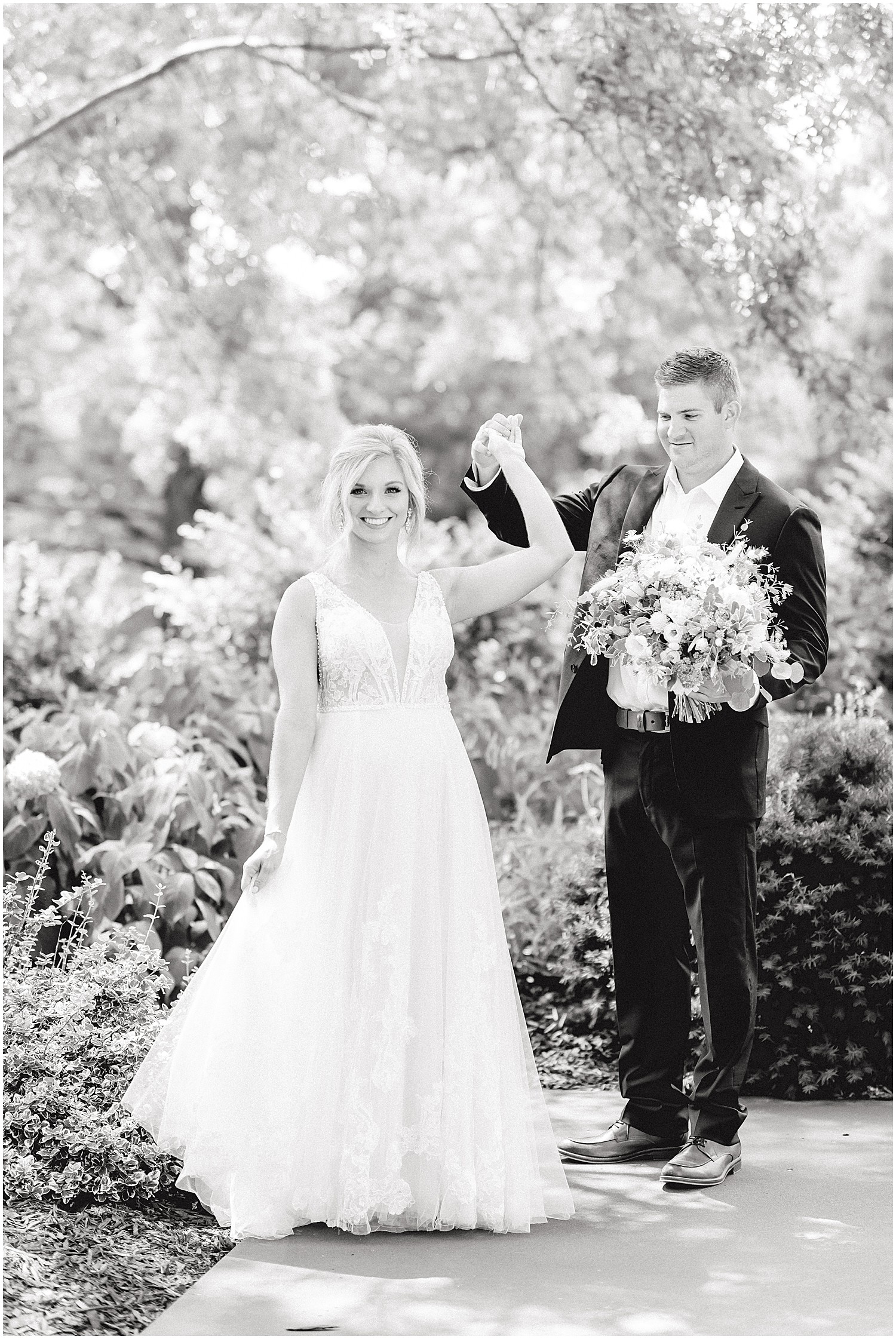 black and white image of bride and groom dancing on patio of little piney lodge