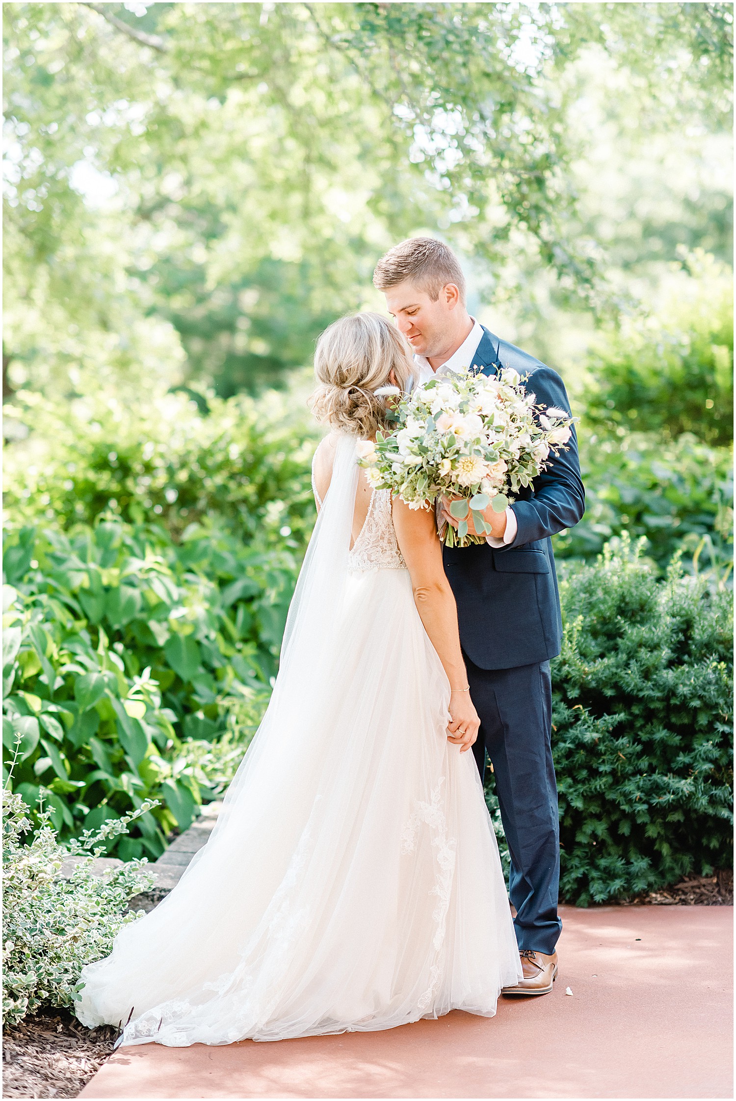 image of bride and groom kissing on patio at little piney lodge before wedding ceremony