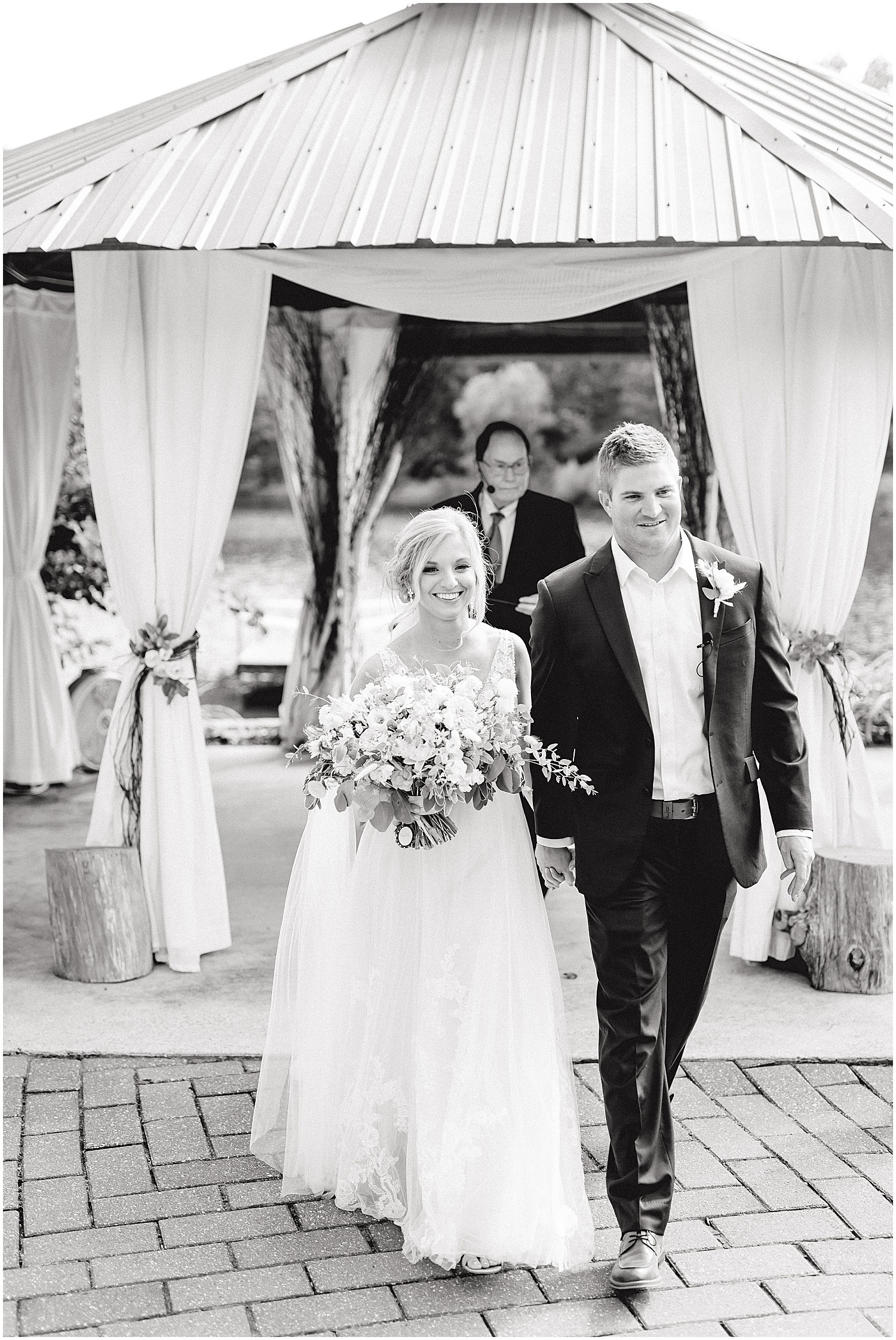black and white image of bride and groom exiting wedding ceremony