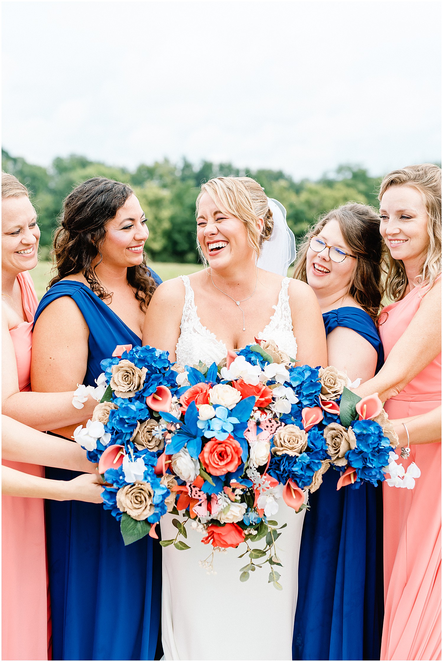 bride smiling with bridesmaids on wedding day