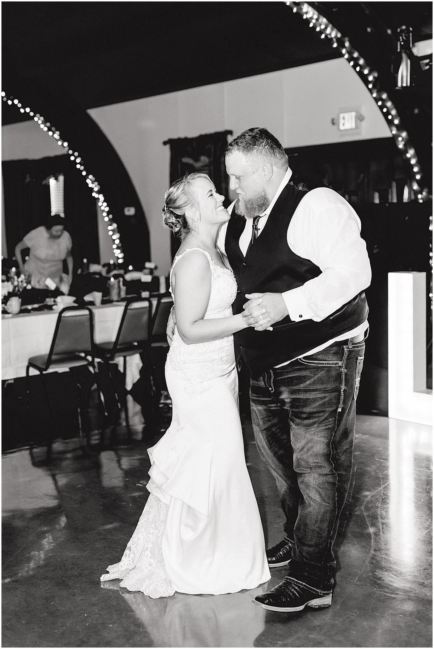 black and white image of bride and groom dancing during wedding reception in Boonville, mo