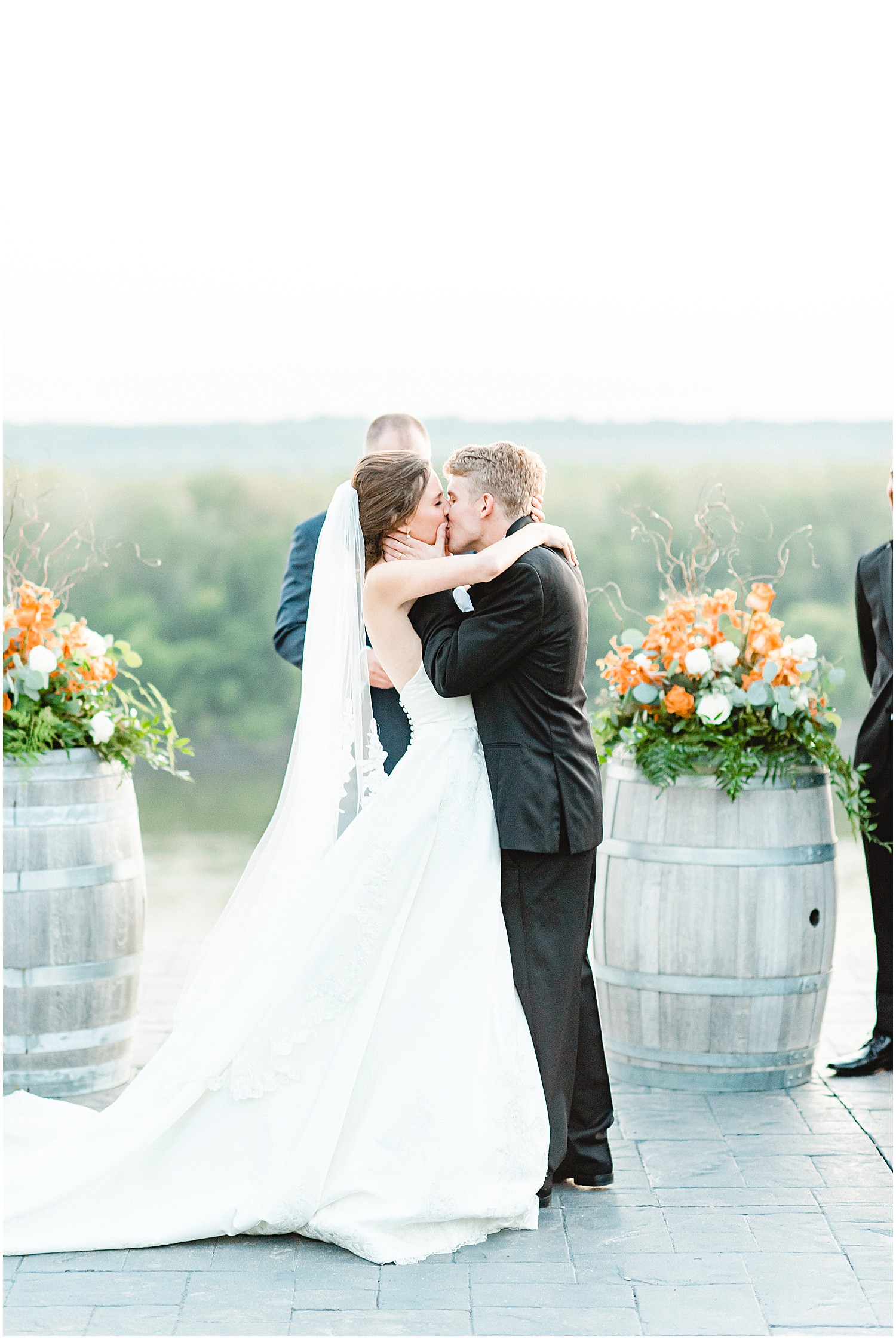 bride and groom sharing a first kiss on the bluff top at les bourgeois winery wedding