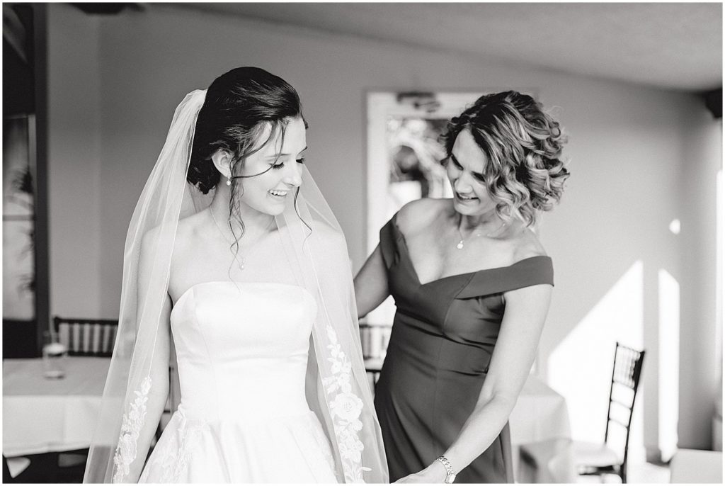 black and white image of bride and mom getting ready on wedding day