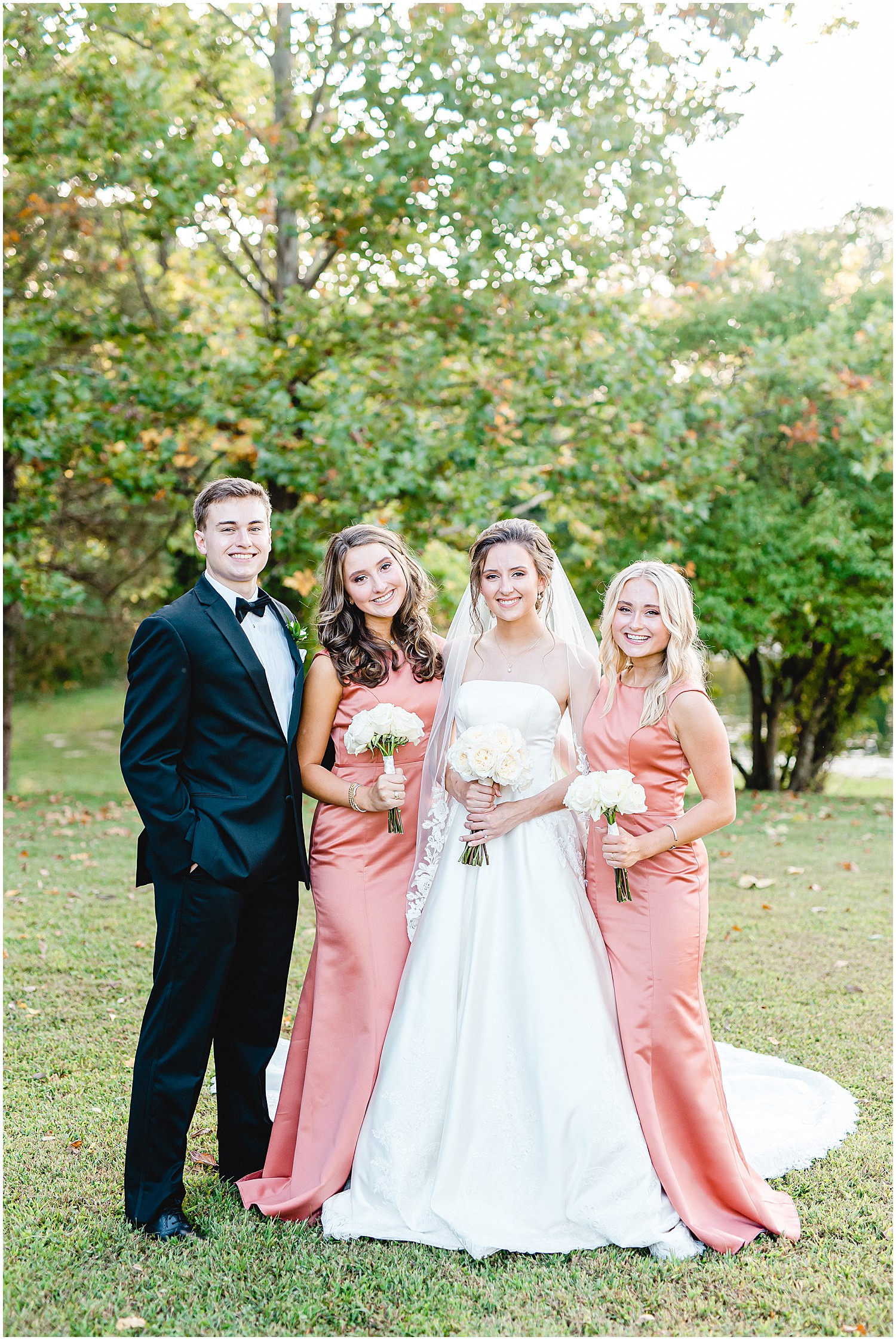 bride and her siblings smiling during wedding party portraits on wedding day