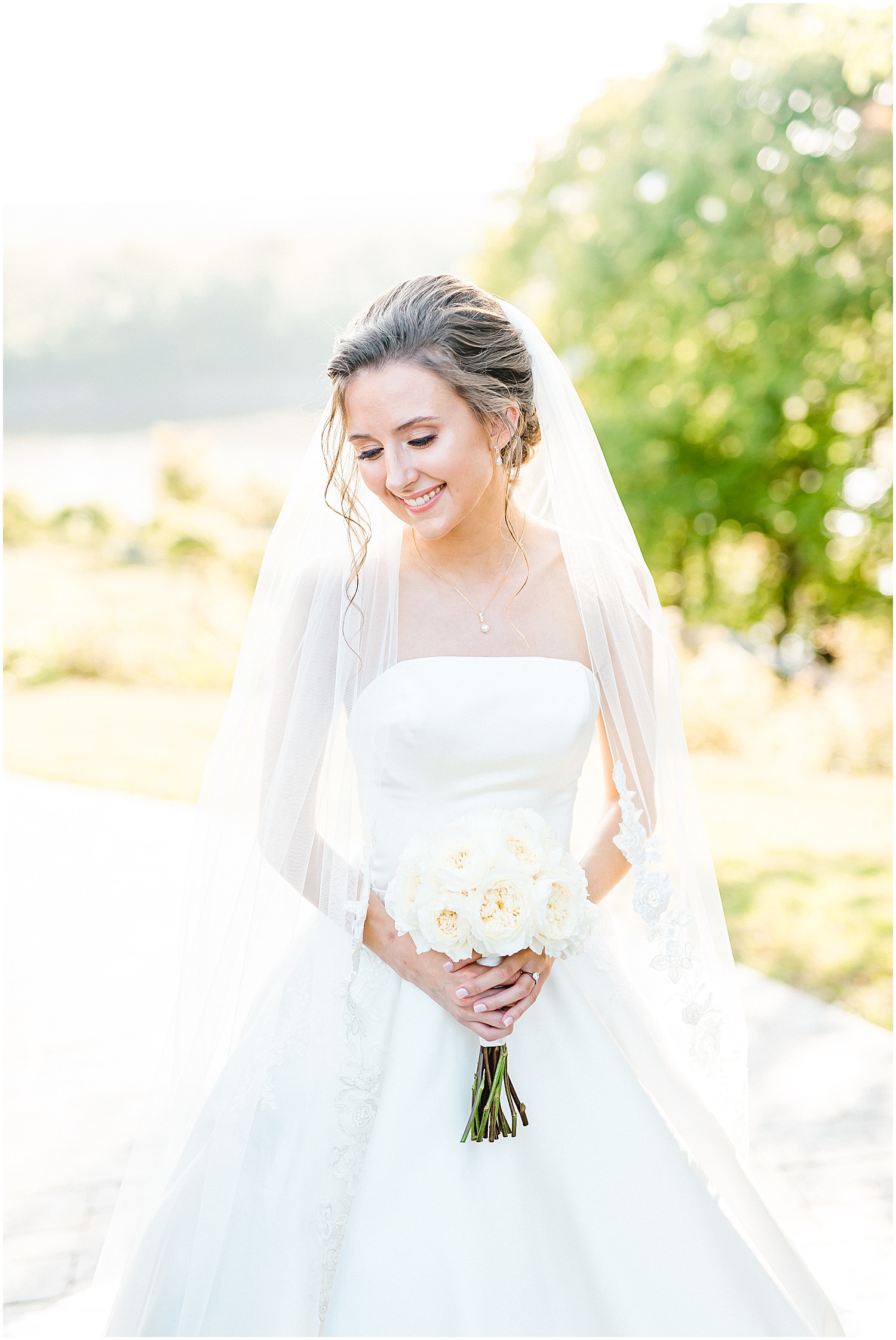 bridal portrait with bouquet and veil over shoulders on wedding day