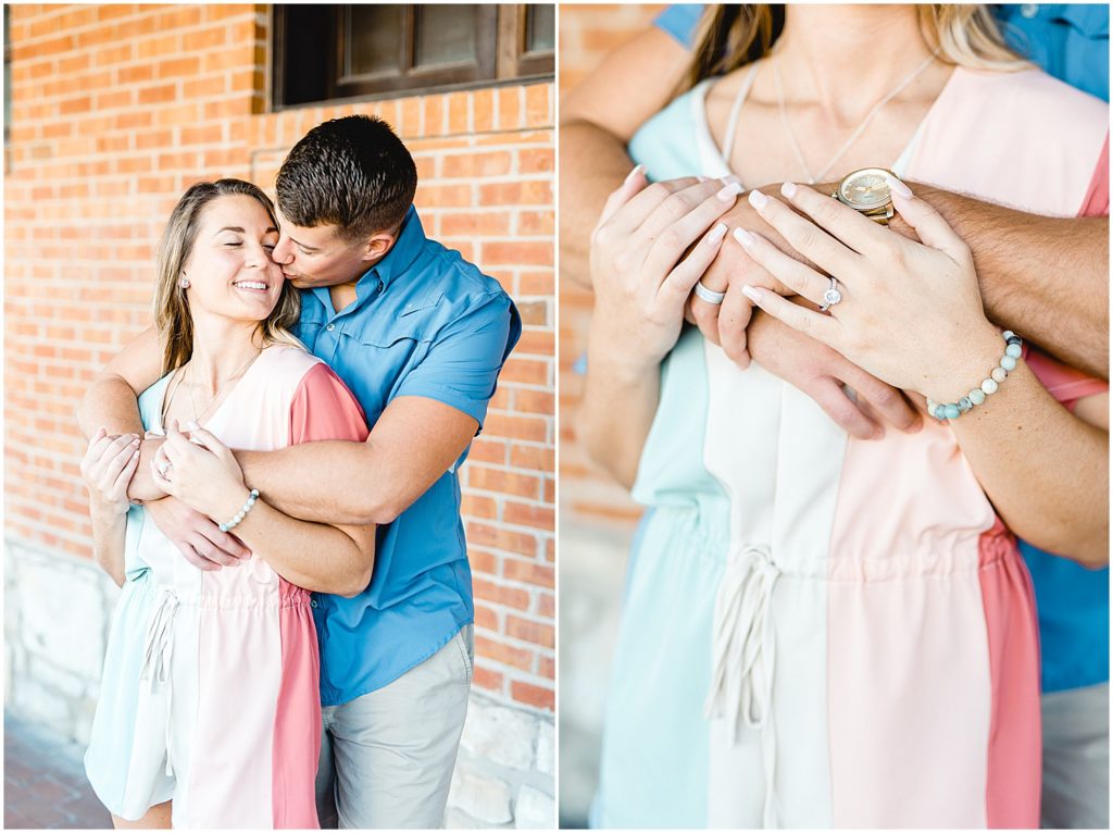 young couple hugging by brick wall at Hermann, mo brewery for engagement photos