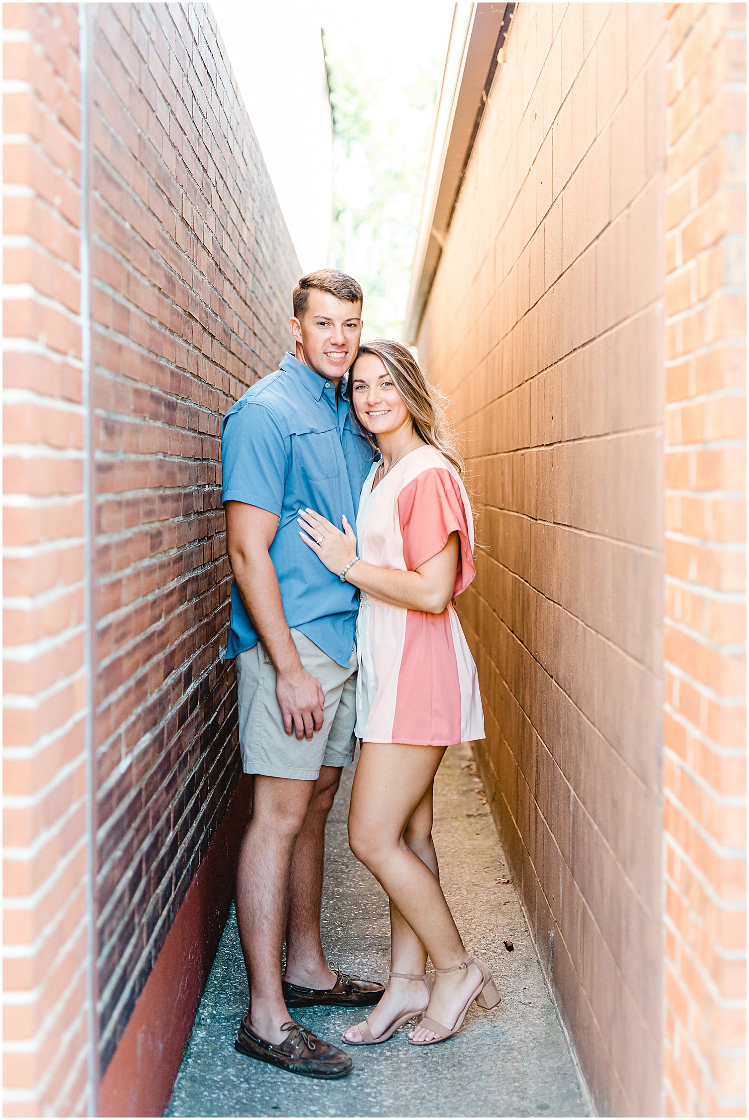 couple stands in alley way during Hermann, mo engagement photos