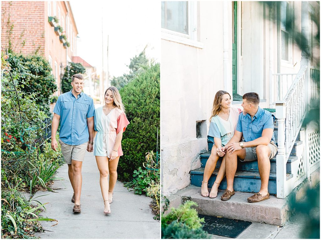 couple smiles surrounded by greenery and sits on stairs to bed and breakfast in Hermann, mo