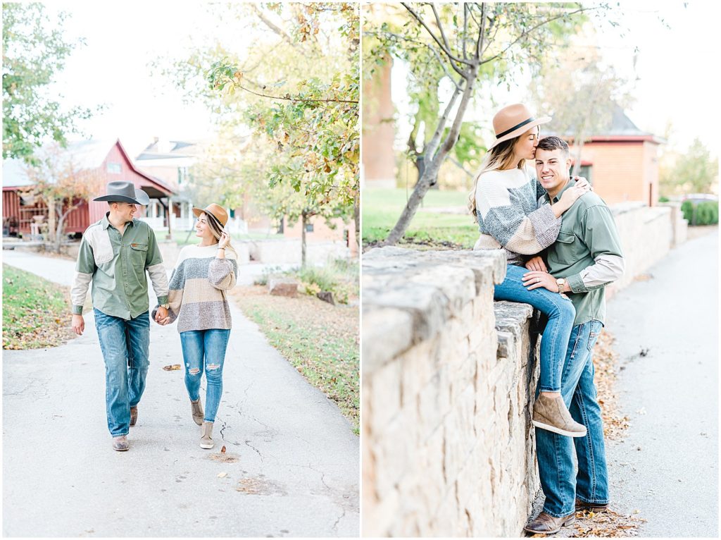 young couple walks down a drive and sits on a rock wall during engagement session at Hermann Farm