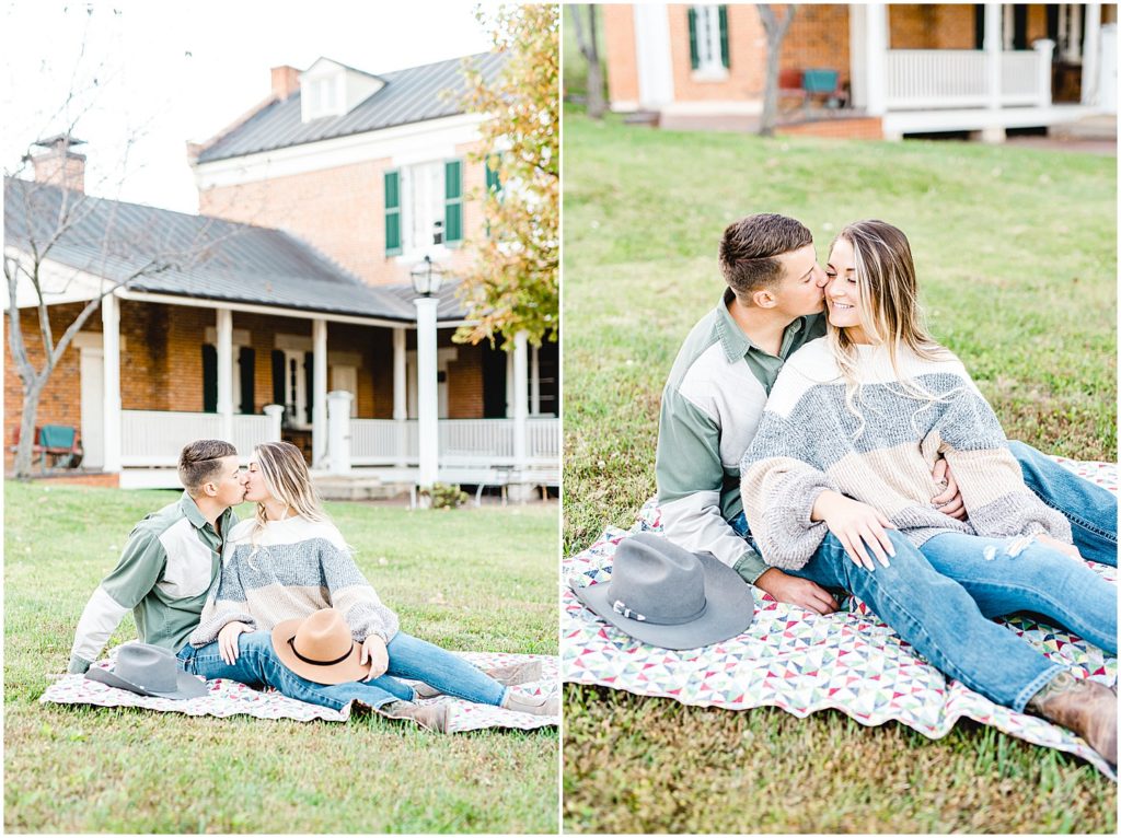 couple kisses on blanket in grass during engagement photos