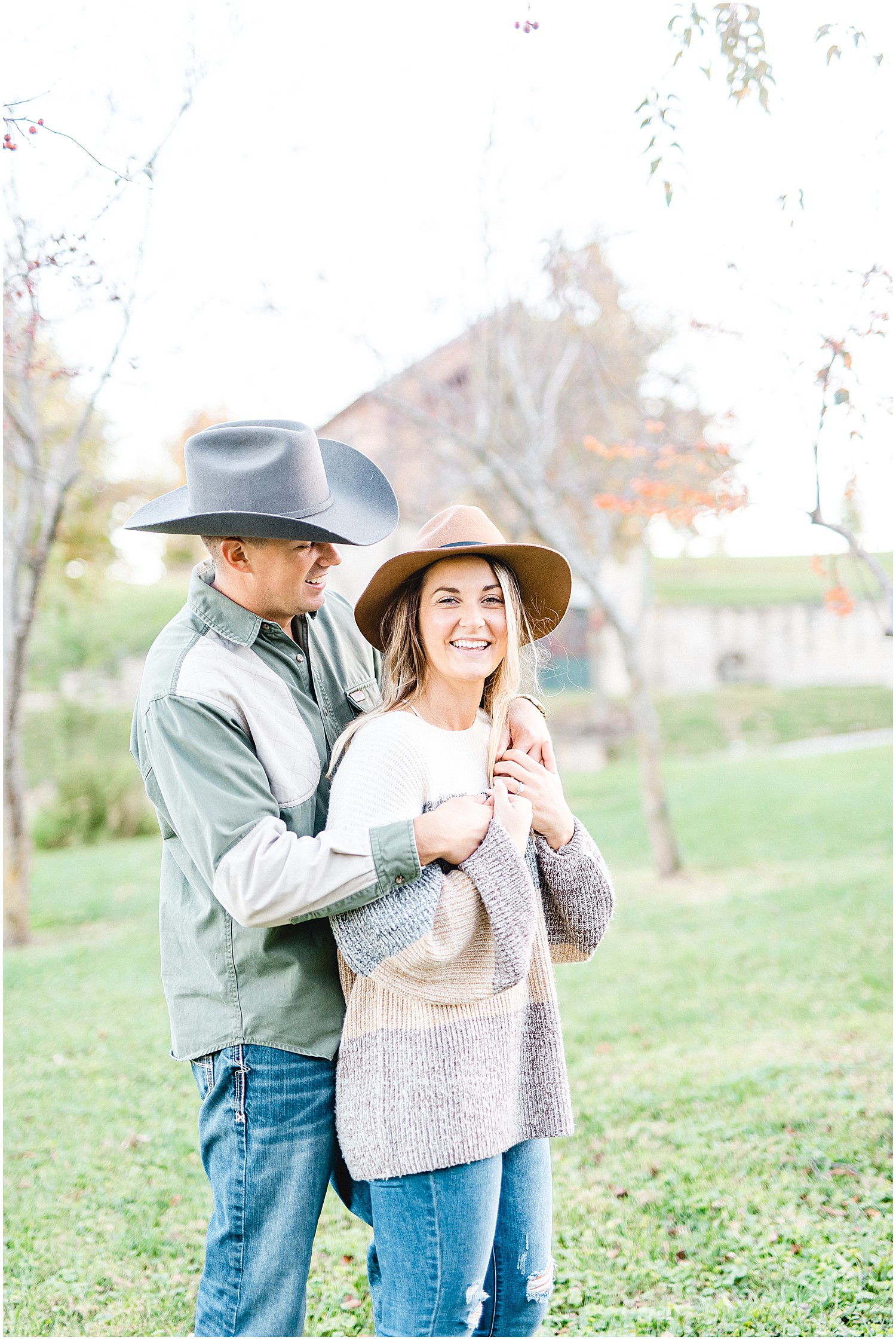 couple laughs while posing for pictures at Hermann Farm