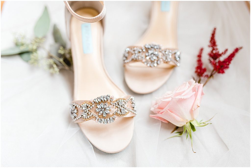 bridal betsey johnson shoe details with pink and maroon flowers.