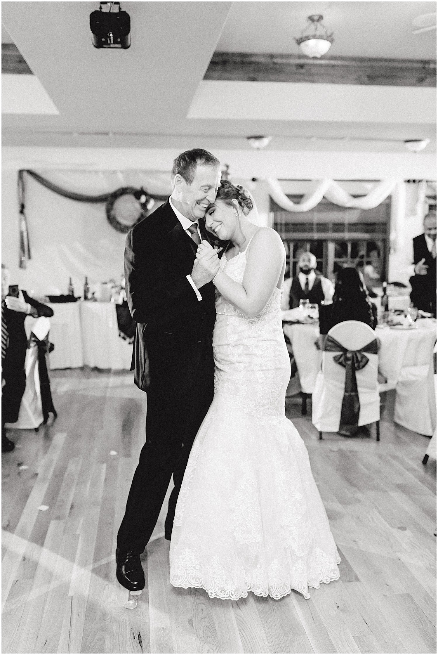 bride and dad first dance during wedding reception in black and white