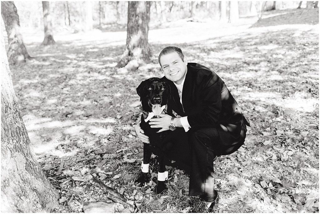 black and white image of groom and dog