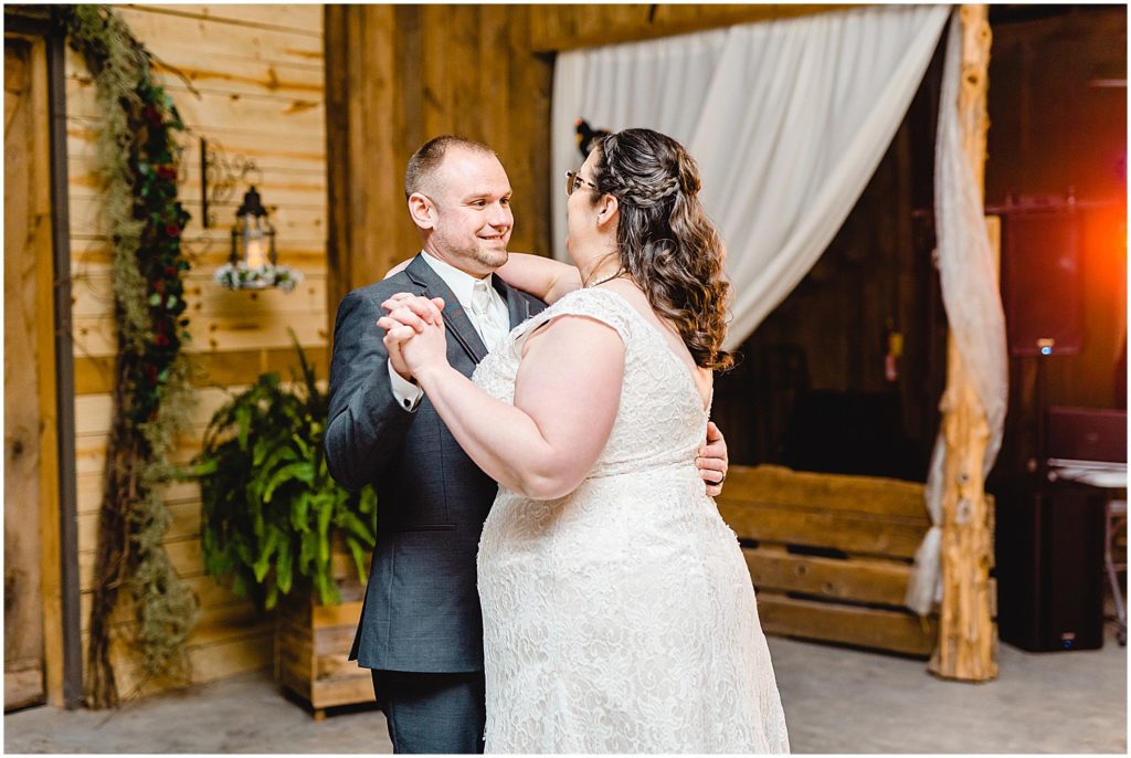 bride and groom first dance during barn reception at wildflower in Eugene, mo