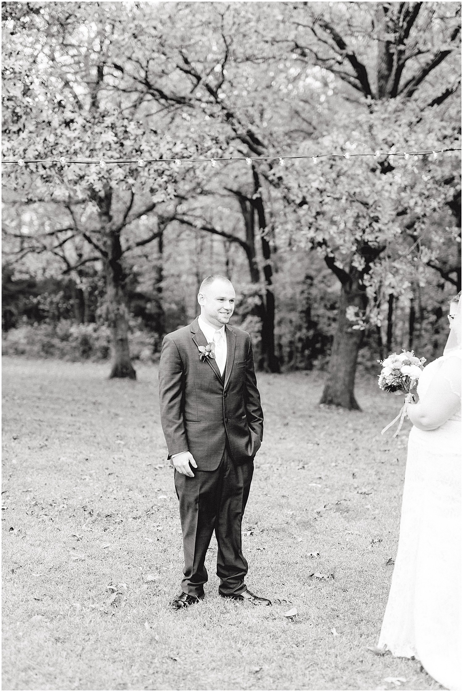 black and white image of groom seeing his bride for the first time on wedding day
