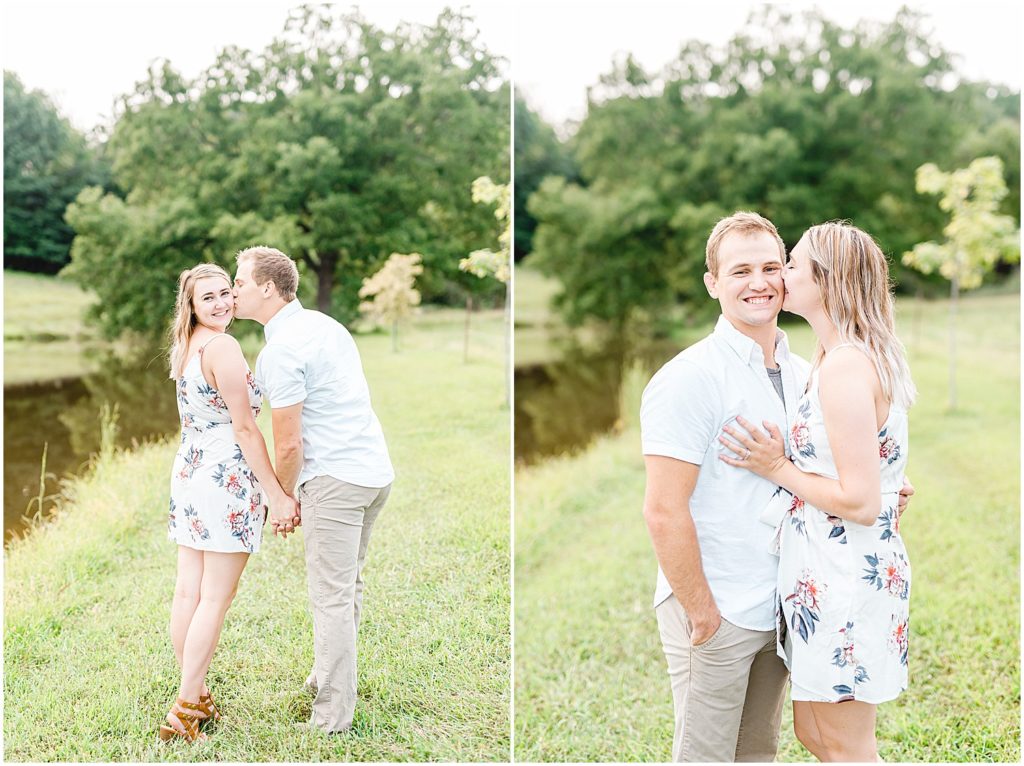 couple stands on grass next to lake and smiles for camera for missouri engagement session
