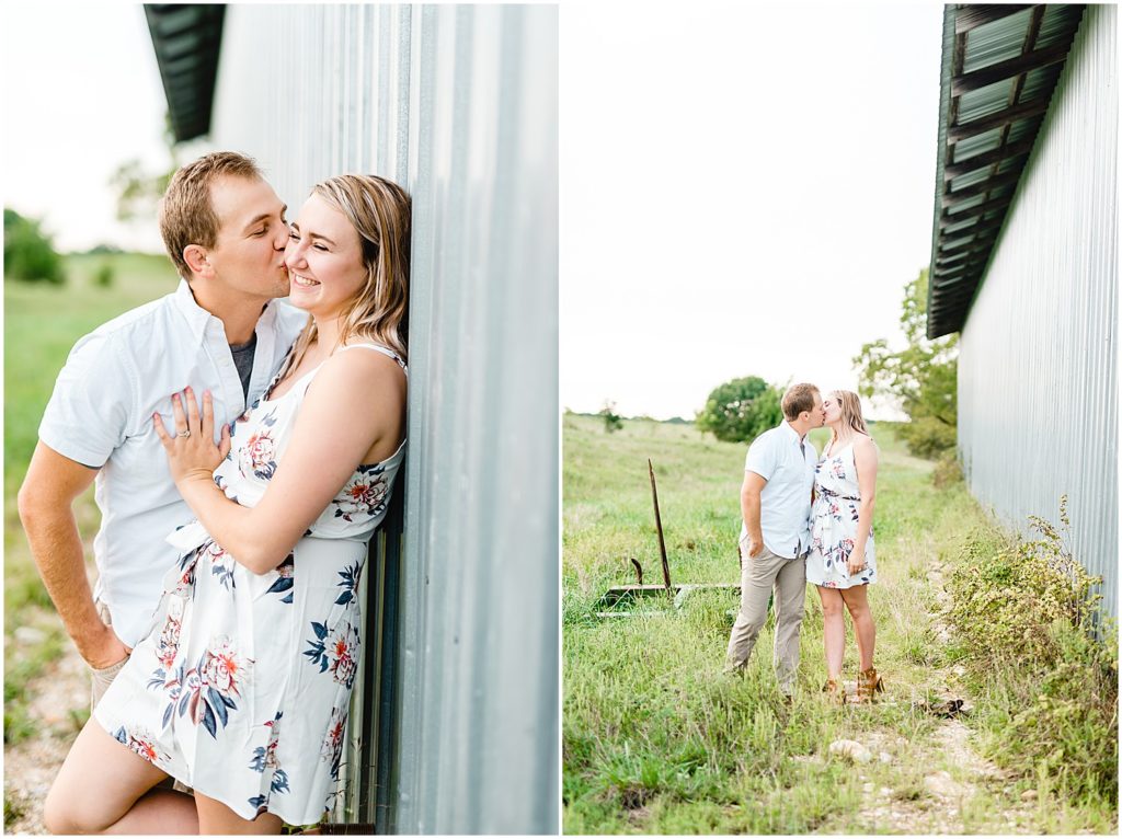 couple stands next to a gray metal barn for engagement pictures in missouri