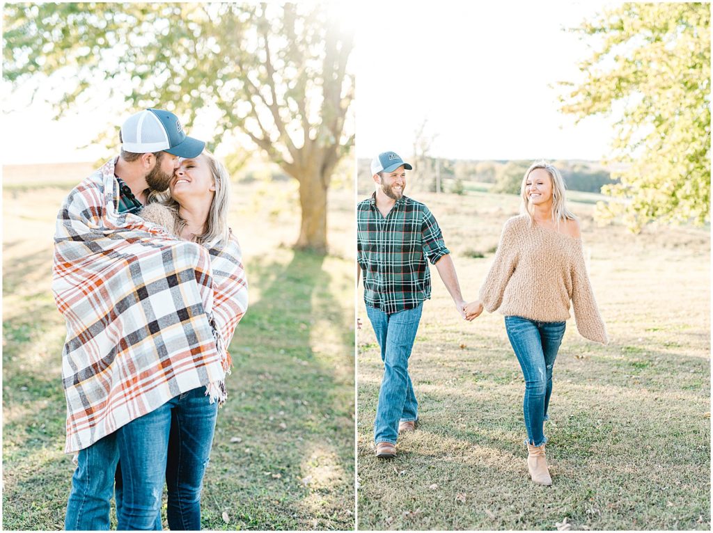 couple walks together holding hands during engagement session on missouri farm