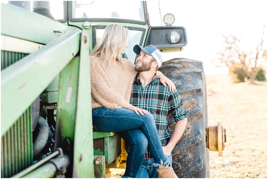 couple smiles at each other on tractor