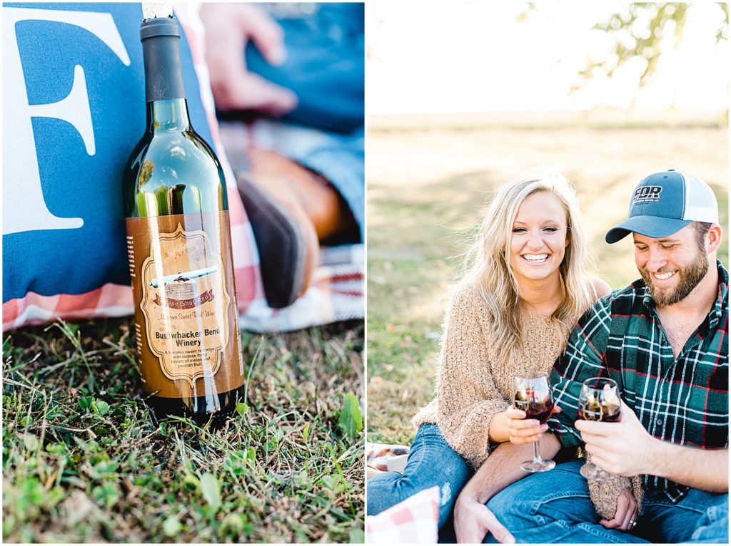couple drinks wine during picnic engagement session in missouri