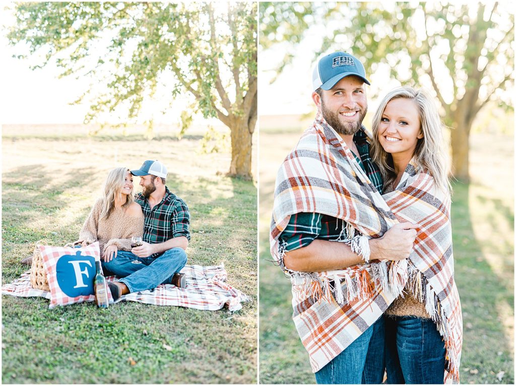 couple smiles at each other wrapped in blanket during engagement pictures in missouri