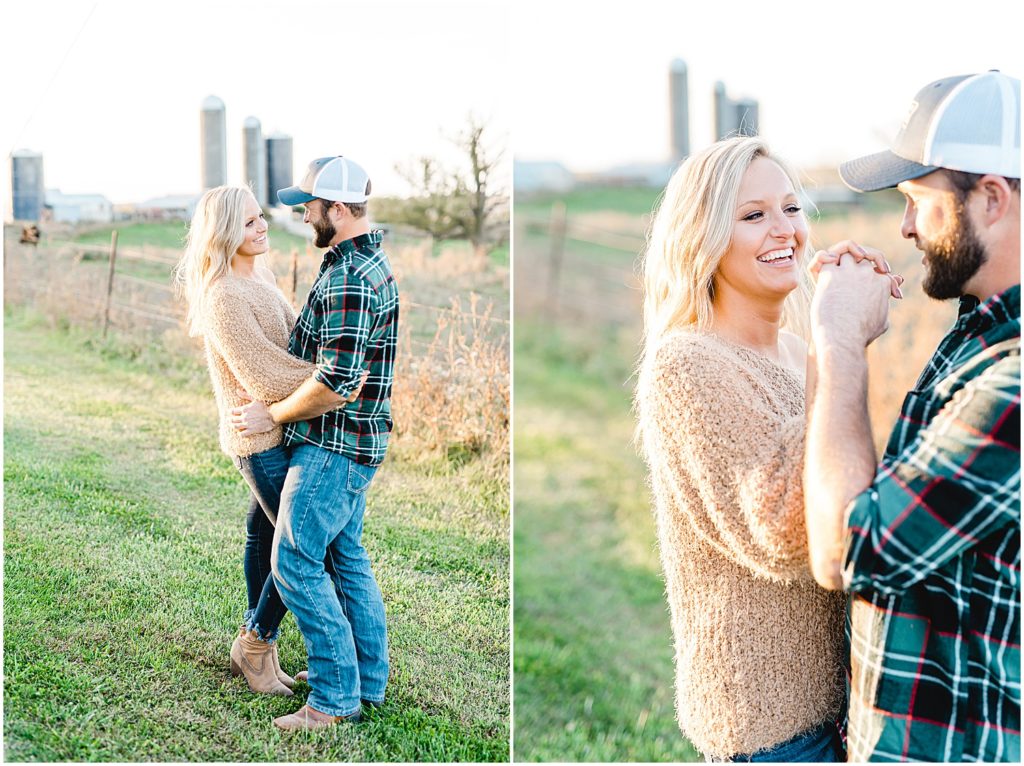couple holds each other for missouri farm engagement session with silos in the background
