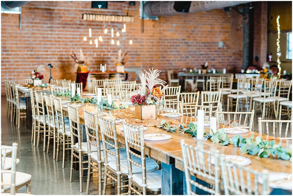 reception details of tables featuring fall florals and gold chairs
