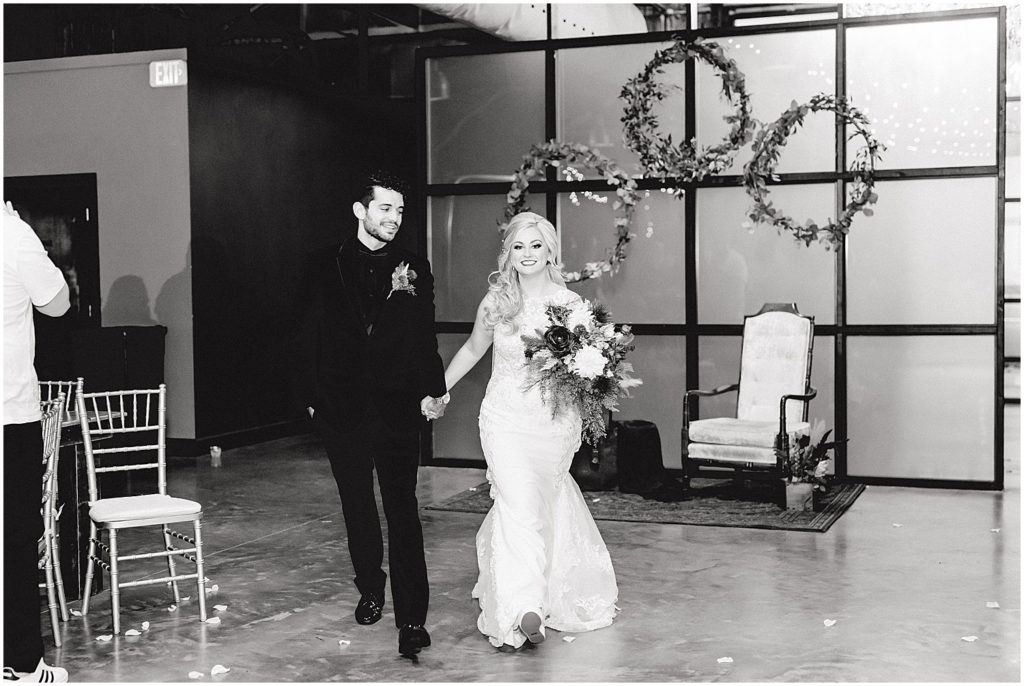 bride and groom enter reception at exchange venue
