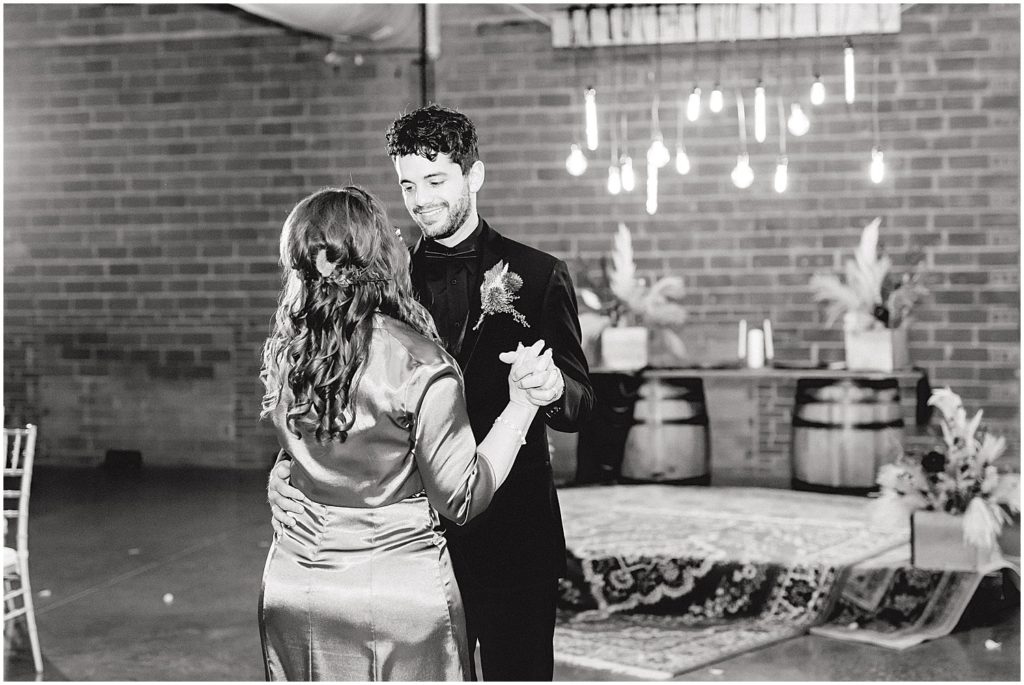 groom and mother dance during wedding reception at exchange venue