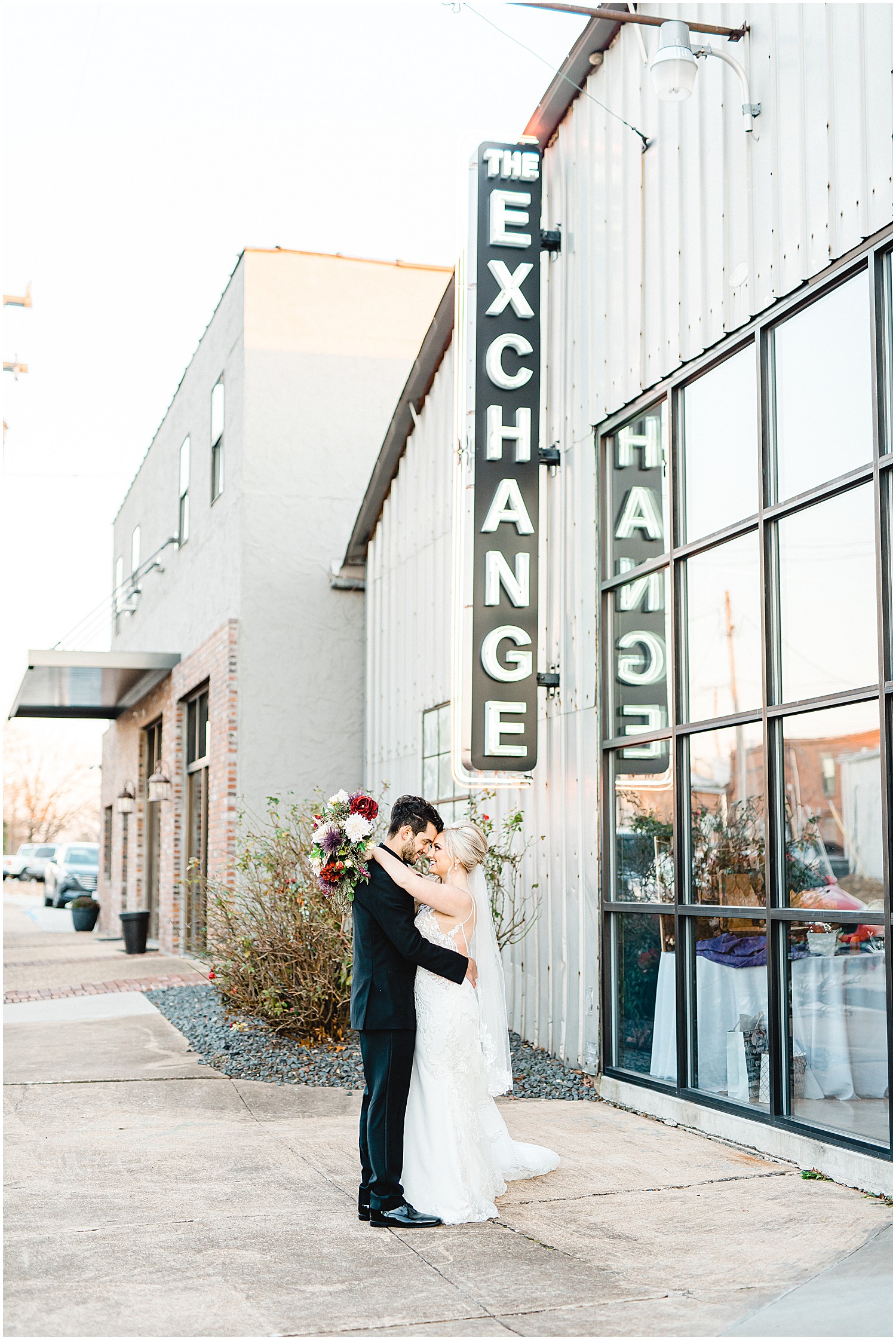 bride and groom stand outside the exchange venue for wedding portraits