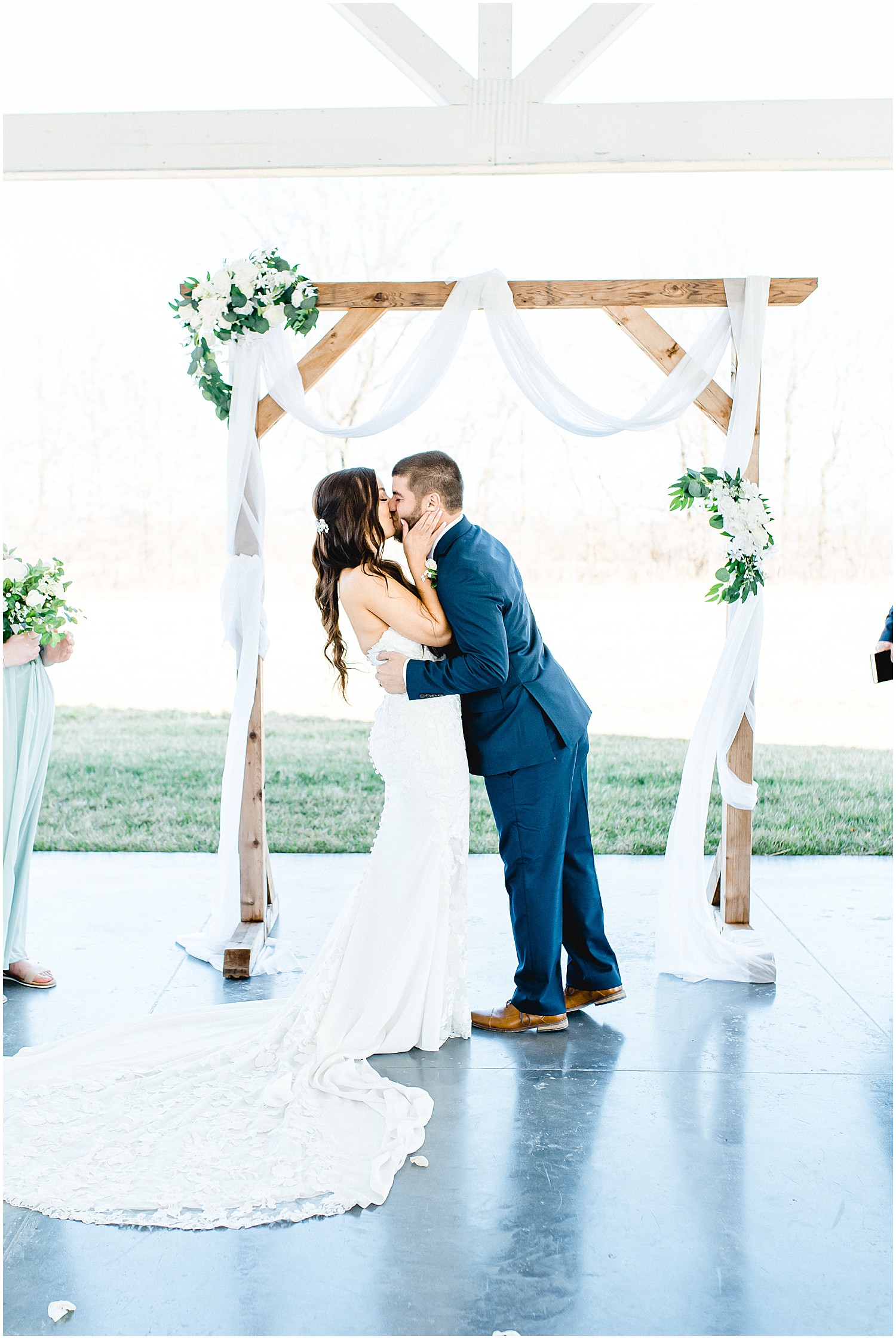 Bride and groom first kiss Ceremony photos in outdoor pavilion at Emerson Fields wedding venue