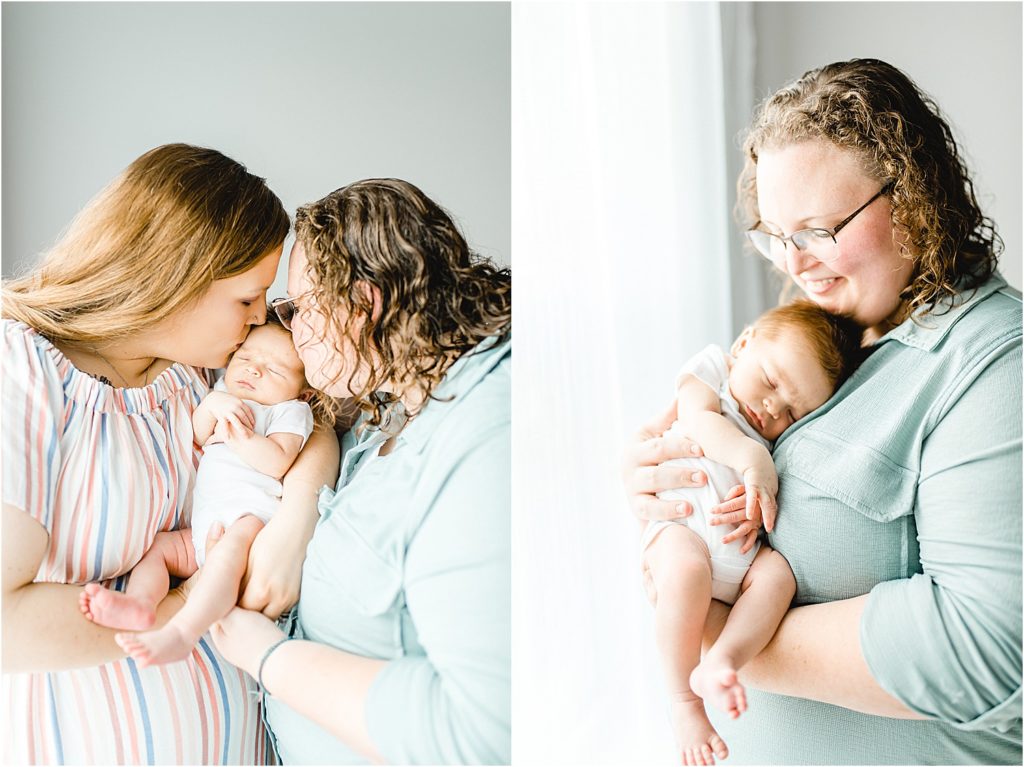 moms hold baby boy in front of window of natural light studio