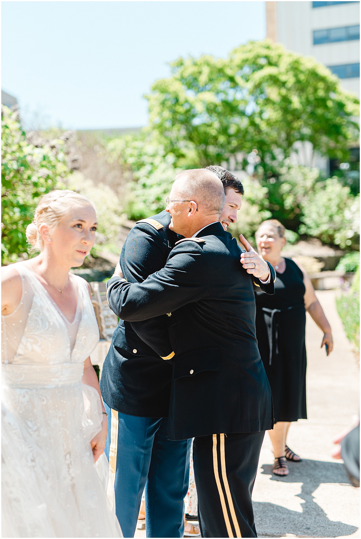 groom hugging father in law during intimate wedding ceremony