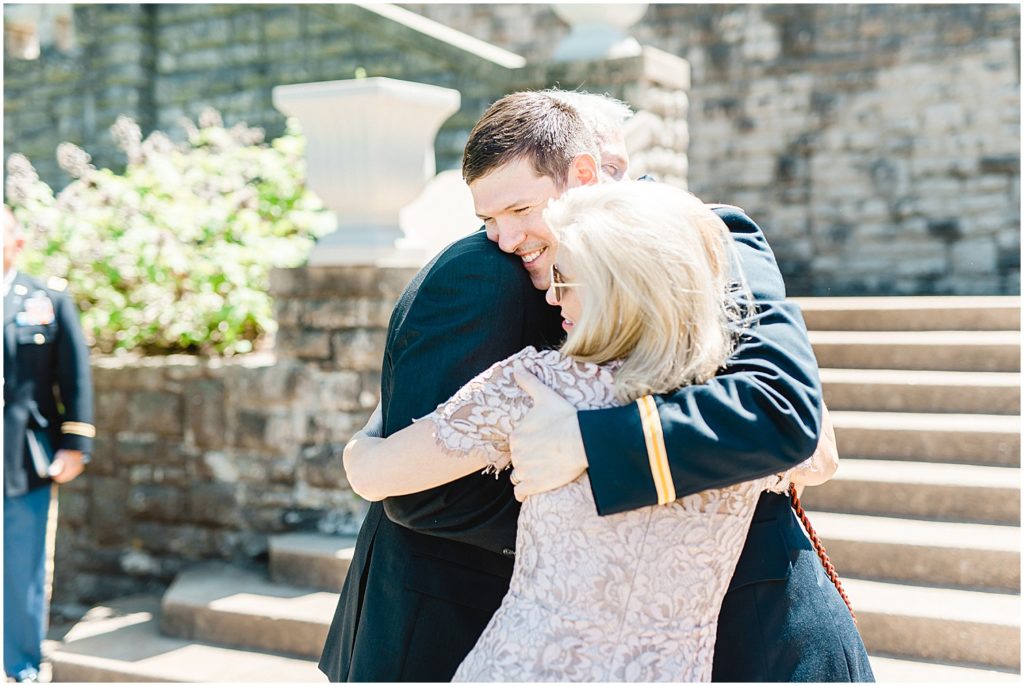 groom hugs parents during intimate wedding ceremony