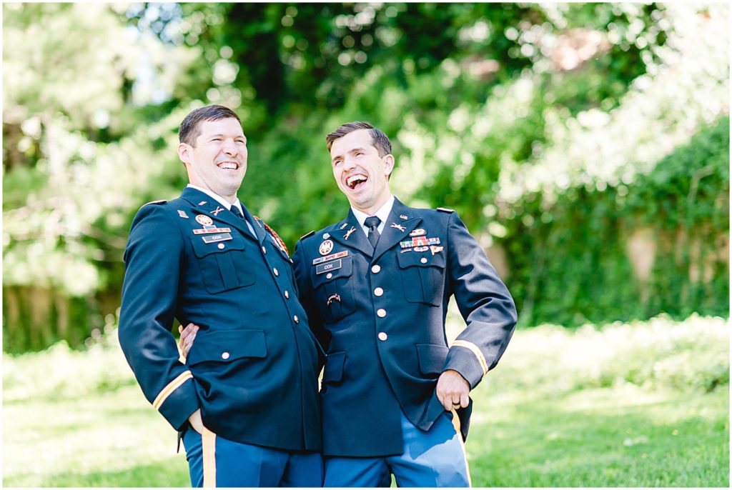 groom and brother laugh during wedding party portraits