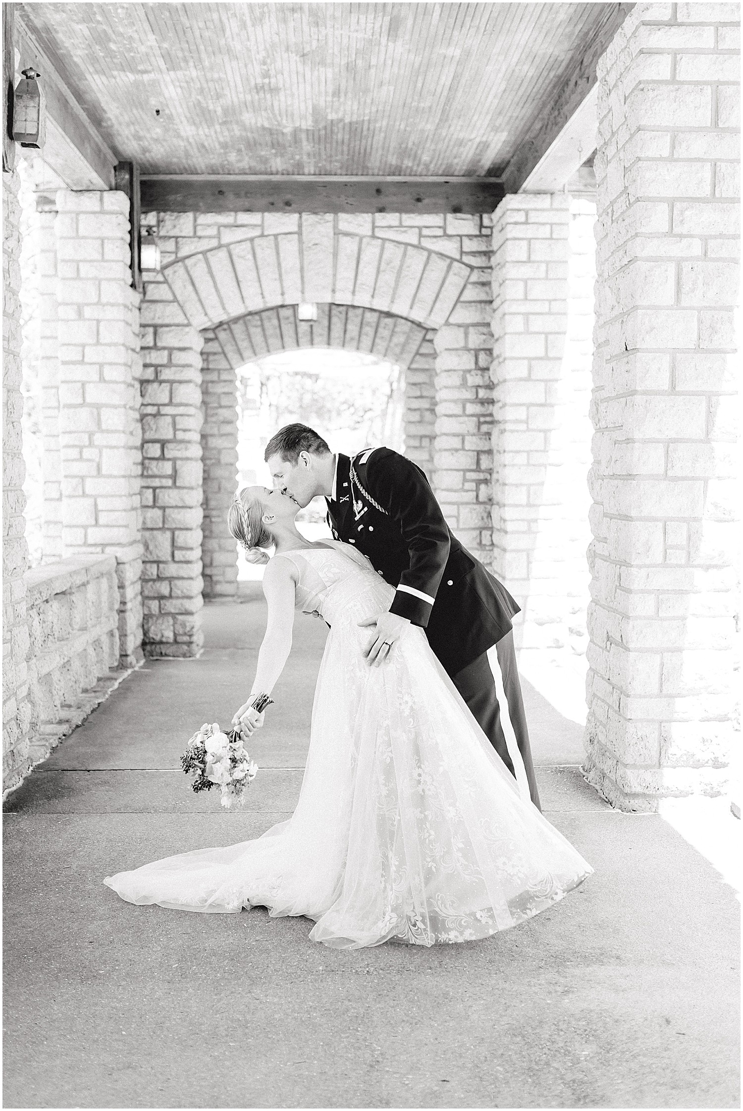 bride and groom kiss at missouri governor's garden pavilion