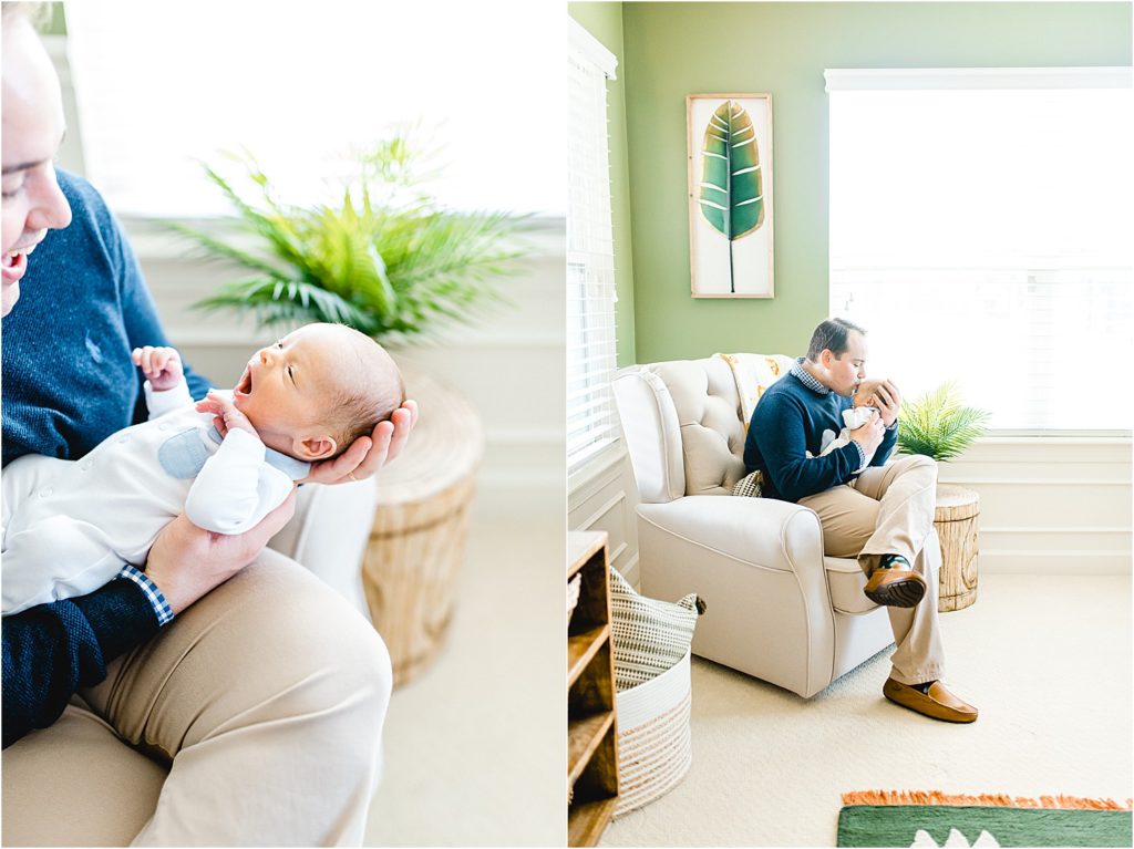 dad holds newborn baby in nursery chair