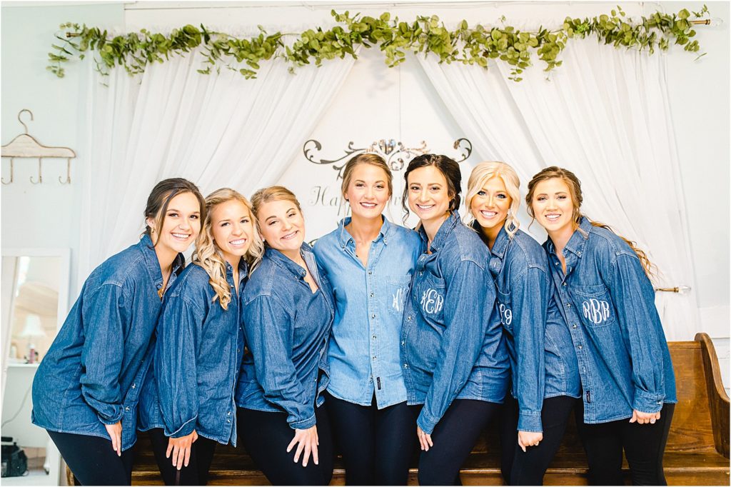 bride and bridesmaids pose in personalized denim shirts