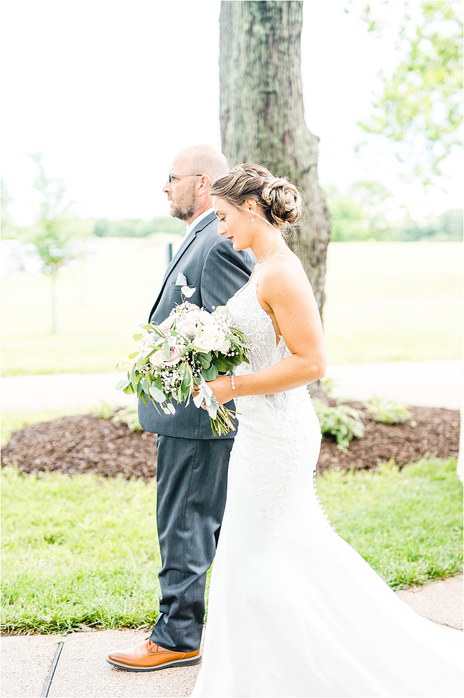 bride and father walk together during wedding ceremony